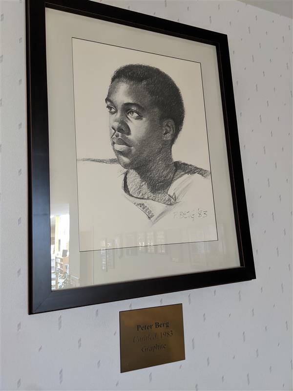 A charcoal drawing of a Black male teenager